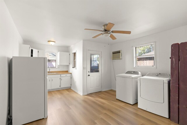 4605 Norhill Blvd, Houston, TX 77009 - clothes washing area with ceiling fan, a sink, light wood-style floors, washing machine and dryer, and a wall unit AC