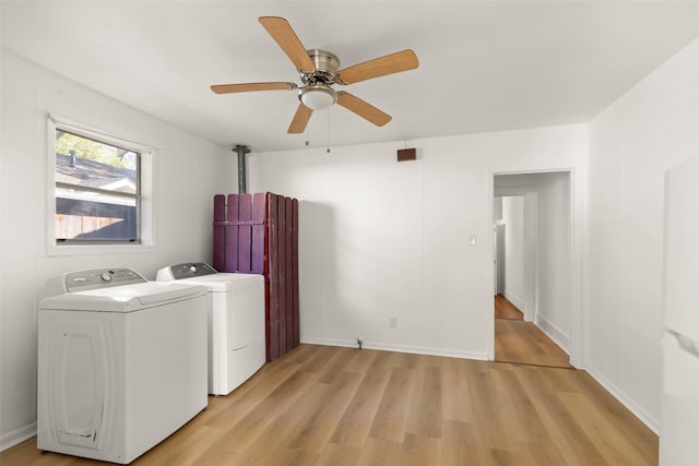 4605 Norhill Blvd, Houston, TX 77009 - washroom featuring washing machine and clothes dryer, light wood finished floors, baseboards, ceiling fan, and laundry area
