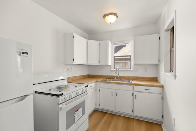 4605 Norhill Blvd, Houston, TX 77009 - kitchen featuring white cabinets, light countertops, white appliances, a sink, and light wood-type flooring