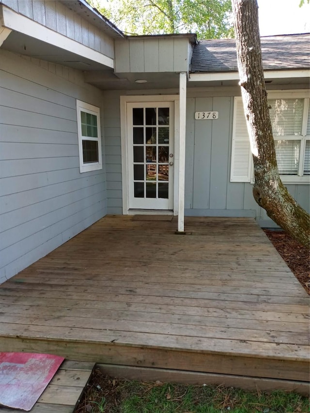 view of exterior entry with a deck