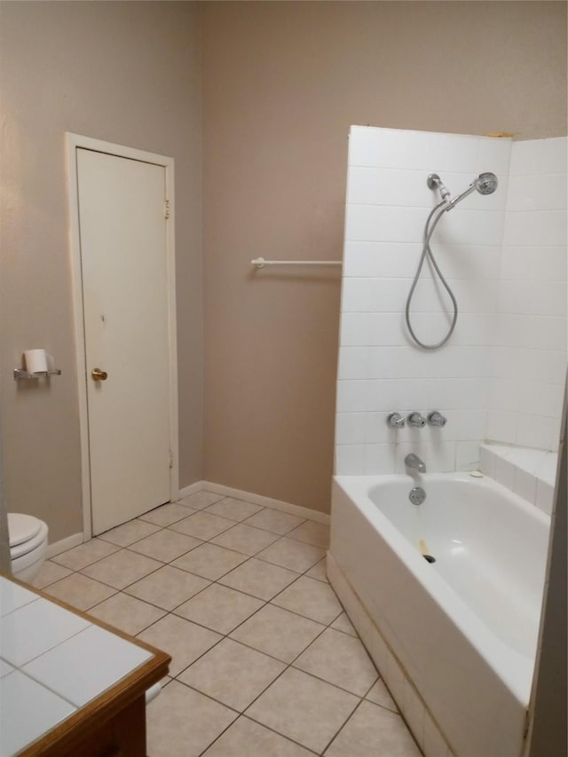 full bath with tile patterned flooring, toilet, baseboards, and bathtub / shower combination