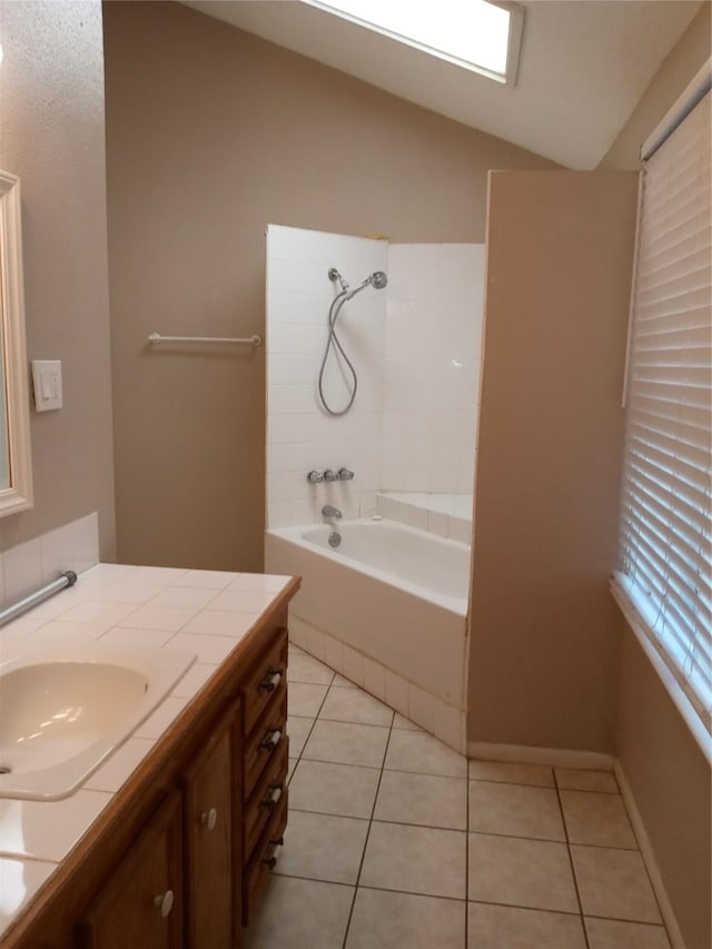 bathroom with lofted ceiling,  shower combination, tile patterned flooring, and vanity