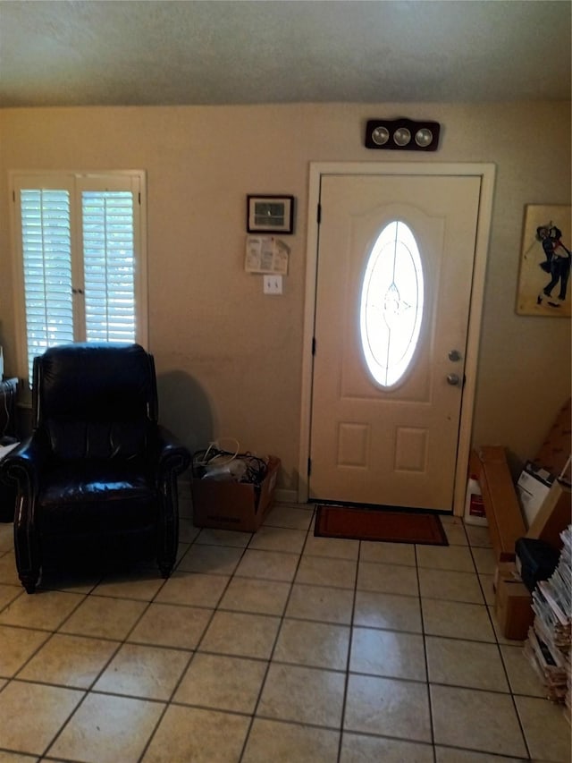 foyer entrance with light tile patterned floors