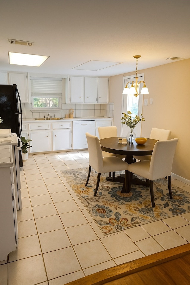 1372 Apache Dr, Montgomery, TX 77316 - dining area with light tile patterned floors and a chandelier