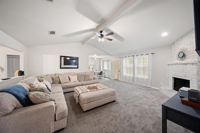 carpeted living room featuring lofted ceiling with beams, baseboards, ceiling fan, visible vents, and a fireplace