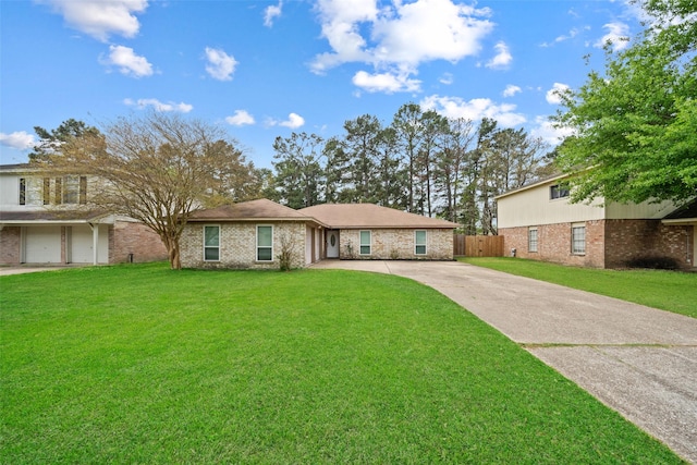 single story home with driveway, fence, and a front yard