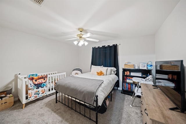 carpeted bedroom with a ceiling fan and visible vents