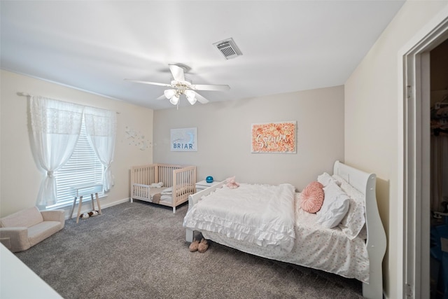carpeted bedroom with visible vents and a ceiling fan