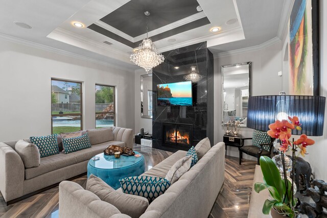 34 New Oak Trl, Humble, TX 77346 - living area with ornamental molding, a high end fireplace, a raised ceiling, and a chandelier