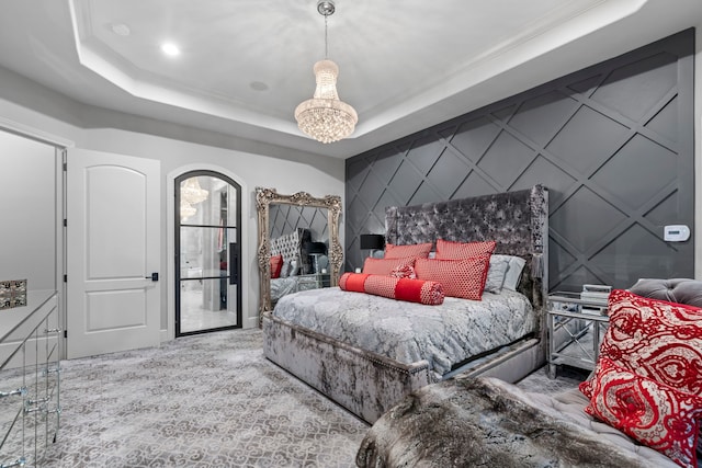 34 New Oak Trl, Humble, TX 77346 - carpeted bedroom featuring a raised ceiling, a decorative wall, a chandelier, and crown molding