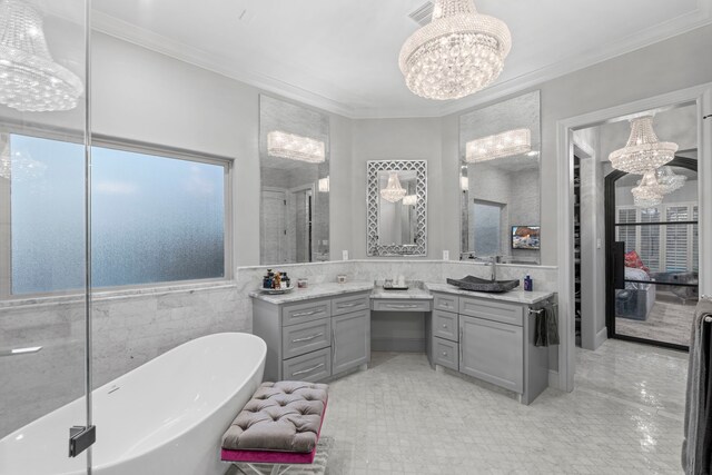 34 New Oak Trl, Humble, TX 77346 - bathroom with a chandelier, vanity, ornamental molding, a soaking tub, and tile walls