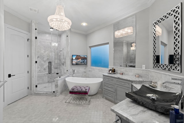 34 New Oak Trl, Humble, TX 77346 - bathroom with crown molding, a shower stall, vanity, a soaking tub, and a chandelier