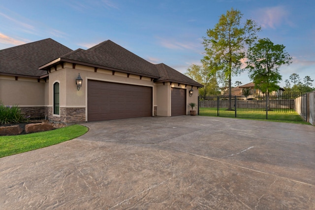 34 New Oak Trl, Humble, TX 77346 - view of front of home with fence, a garage, stucco siding, concrete driveway, and stone siding