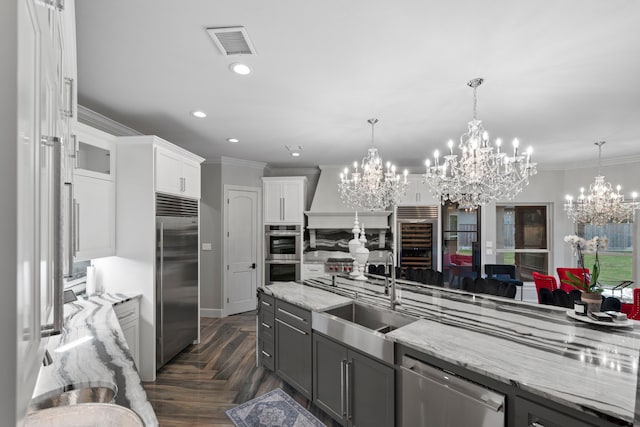 34 New Oak Trl, Humble, TX 77346 - kitchen with a sink, wine cooler, visible vents, a chandelier, and appliances with stainless steel finishes