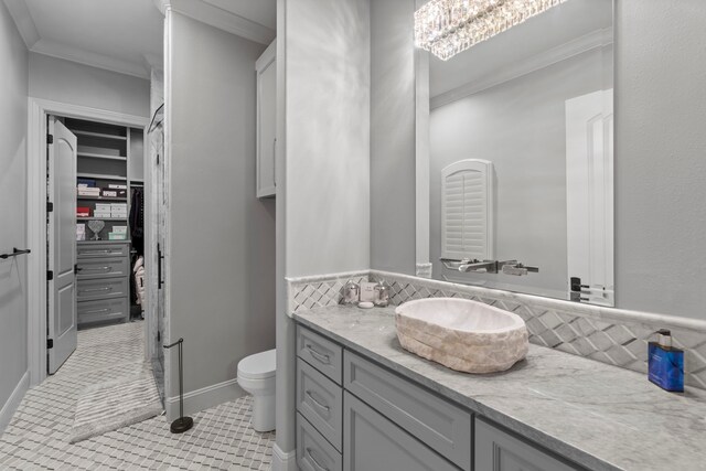 34 New Oak Trl, Humble, TX 77346 - bathroom with vanity, toilet, ornamental molding, tile patterned flooring, and a spacious closet