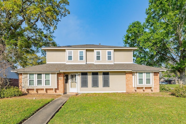 traditional-style house with brick siding, solar panels, and a front lawn