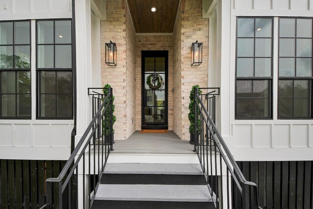 1107 Grovewood Ln, Houston, TX 77008 - doorway to property with board and batten siding, a porch, stone siding, and brick siding