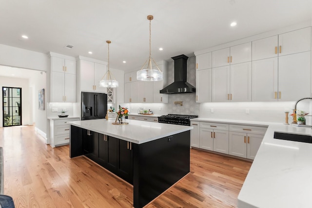 1107 Grovewood Ln, Houston, TX 77008 - kitchen featuring wall chimney exhaust hood, black fridge with ice dispenser, a sink, backsplash, and light countertops