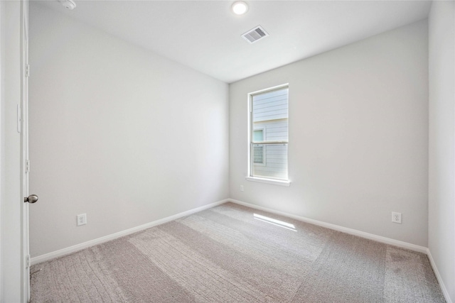 carpeted empty room with baseboards and visible vents