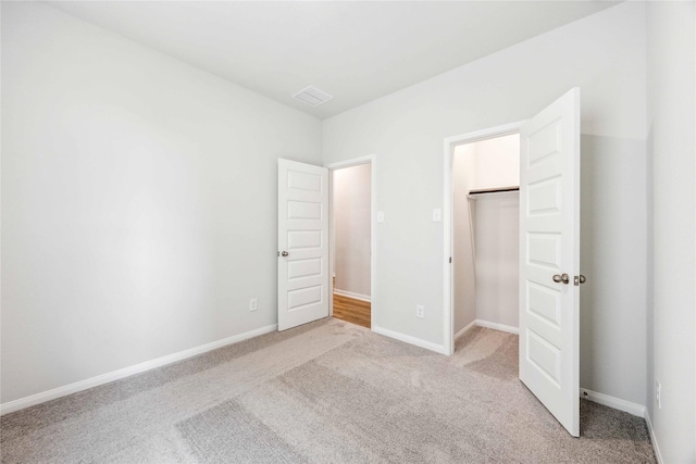 unfurnished bedroom with a closet, carpet, and baseboards