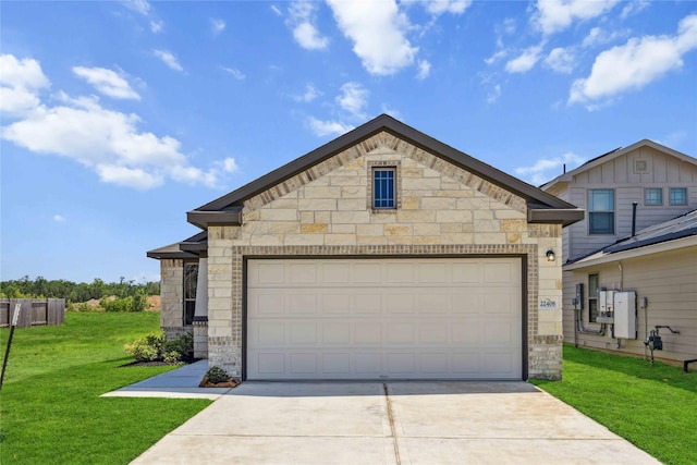 view of front of home featuring a front yard, driveway, and stone siding