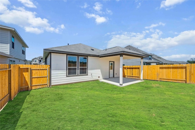 back of property featuring a patio, a fenced backyard, and a lawn