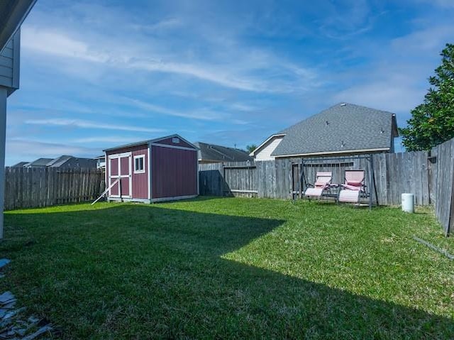view of yard with a fenced backyard, an outdoor structure, and a shed