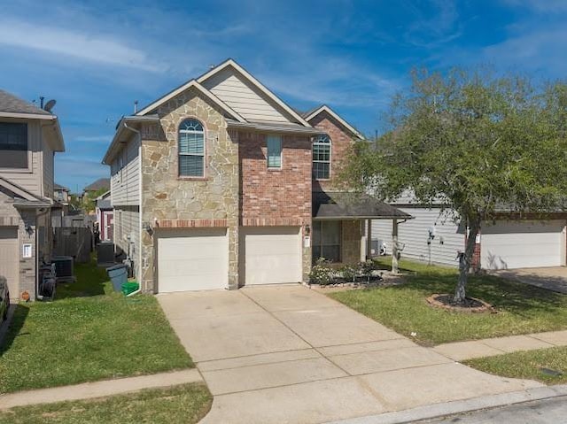 traditional home featuring cooling unit, stone siding, driveway, a front yard, and a garage
