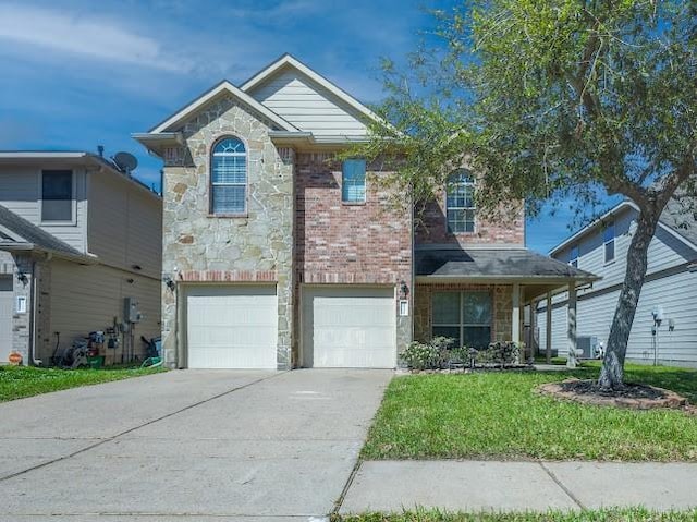 traditional home featuring stone siding, driveway, a front yard, brick siding, and a garage