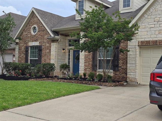 4321 Juniper Ln, Deer Park, TX 77536 - view of front facade featuring roof with shingles, a front yard, driveway, stone siding, and an attached garage