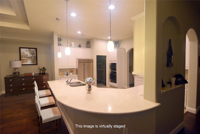 4321 Juniper Ln, Deer Park, TX 77536 - kitchen featuring stainless steel appliances, arched walkways, a sink, white cabinets, and dark wood finished floors