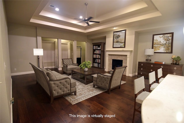 4321 Juniper Ln, Deer Park, TX 77536 - living area with a raised ceiling, ceiling fan, dark wood-type flooring, a tiled fireplace, and recessed lighting