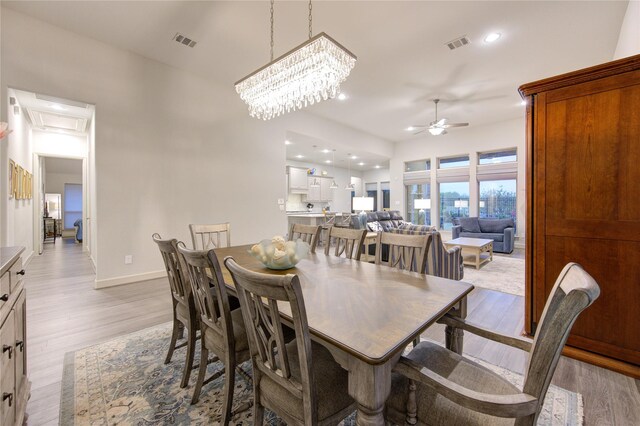 dining room featuring recessed lighting, ceiling fan with notable chandelier, baseboards, light wood finished floors, and visible vents