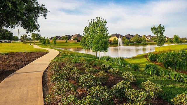 surrounding community with a lawn, a water view, and a residential view