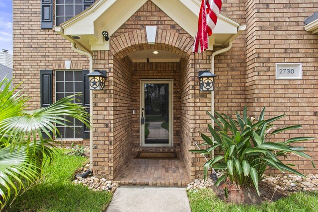 entrance to property with brick siding