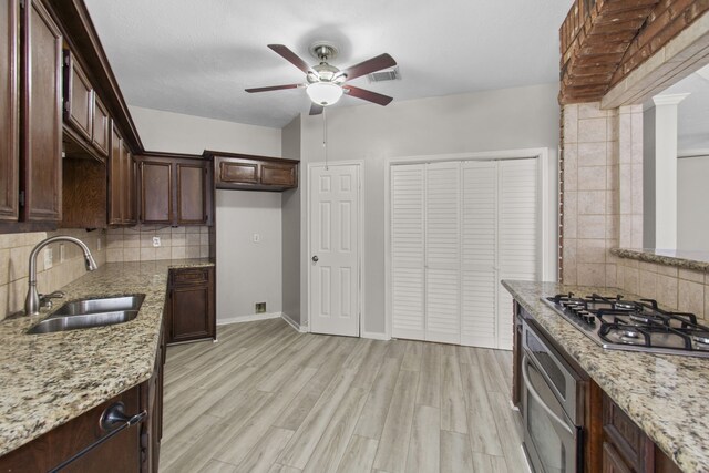 kitchen featuring a sink, appliances with stainless steel finishes, tasteful backsplash, and ceiling fan
