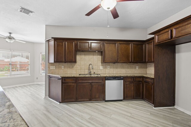 kitchen featuring ceiling fan, visible vents, tasteful backsplash, dishwasher, and a sink