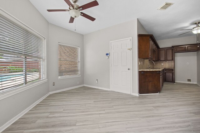 kitchen featuring visible vents, dark brown cabinets, ceiling fan, tasteful backsplash, and light wood-style flooring