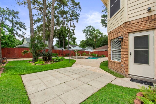 view of yard with a fenced backyard and a patio area