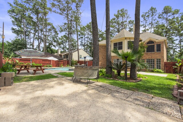 view of patio with an outdoor pool and a fenced backyard
