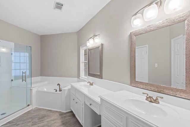 full bath featuring visible vents, a sink, a bath, and a stall shower