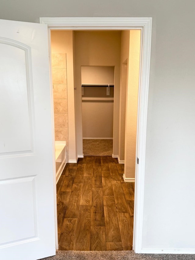 interior space featuring baseboards and dark wood-style floors