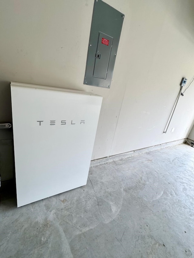 details with unfinished concrete floors and electric panel