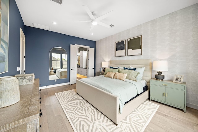 bedroom featuring baseboards, light wood-style flooring, visible vents, and wallpapered walls