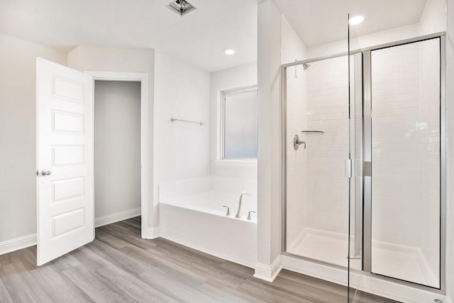 4334 W Bayou Maison Cir, Dickinson, TX 77539 - bathroom with a bath, a shower stall, wood finished floors, and recessed lighting