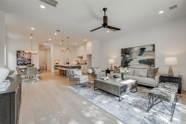 2113 Huldy St, Houston, TX 77019 - living room featuring a chandelier, ceiling fan, light wood-style flooring, and recessed lighting