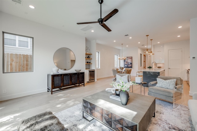 2113 Huldy St, Houston, TX 77019 - living area featuring baseboards, recessed lighting, a chandelier, a ceiling fan, and light wood-style flooring
