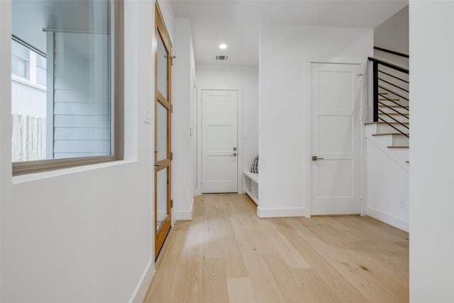 2113 Huldy St, Houston, TX 77019 - corridor featuring light wood-style floors, stairs, baseboards, and recessed lighting