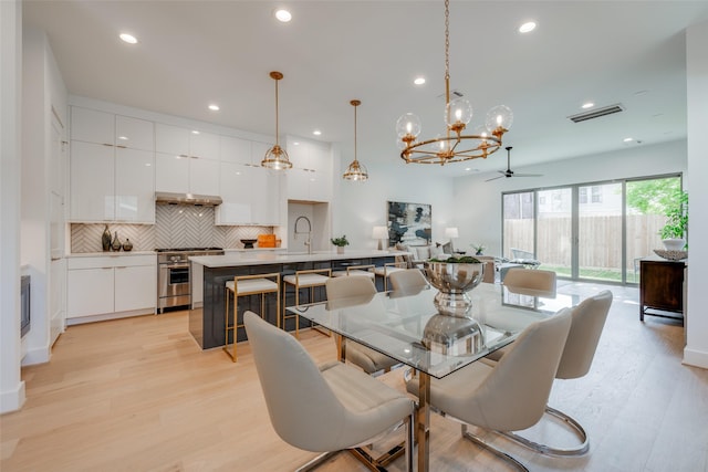2113 Huldy St, Houston, TX 77019 - dining area featuring a chandelier, light wood-style flooring, recessed lighting, and ceiling fan
