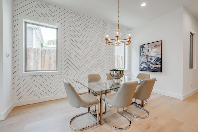 2113 Huldy St, Houston, TX 77019 - dining space with an accent wall, wallpapered walls, baseboards, wood finished floors, and a chandelier